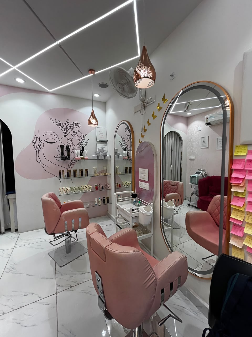 Hair styling stations with arched mirrors at Signature Beauty Lounge