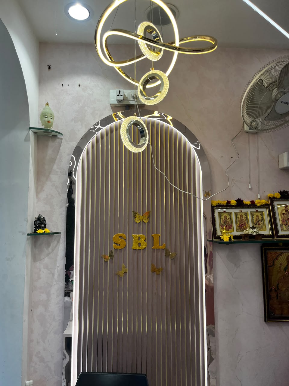Gold SBL lettering and butterflies on the arched feature wall at Signature Beauty Lounge